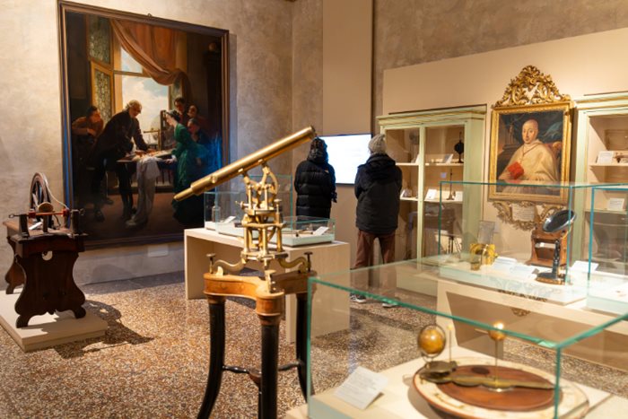 Photos of visitors in one of the physics galleries at the Palazzo Poggi Museum