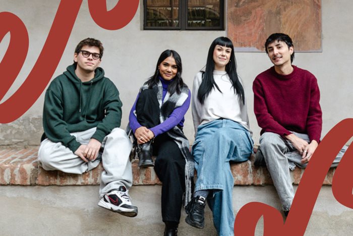 Two boys and two girls sitting on a low wall.
