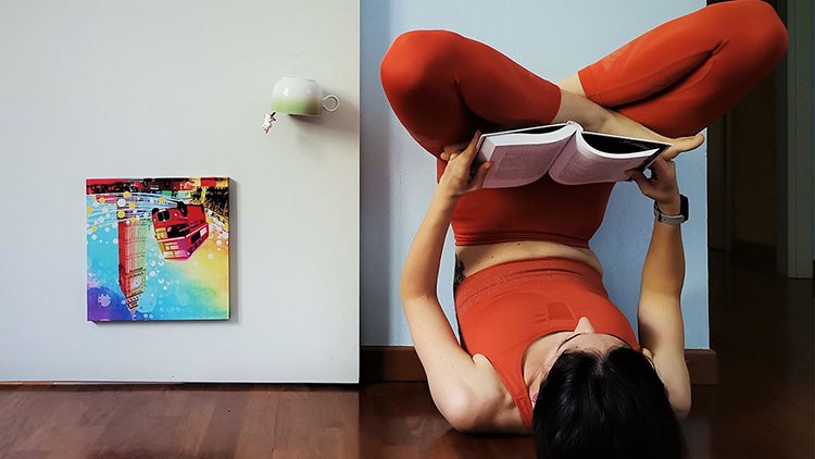 Person reading while doing yoga